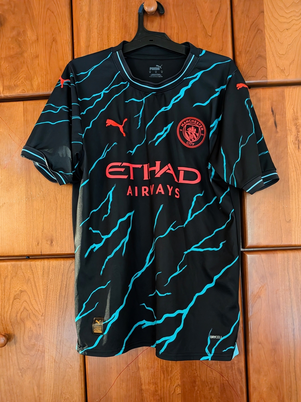 Puma Black Manchester City Jersey with Teal Lightning and Coral Accents